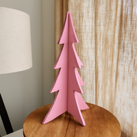 Pastel pink wooden Christmas tree decoration on a side table