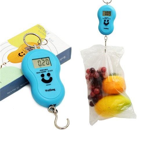 Hanging digital scale weighing a bag of fruit