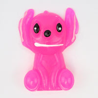 Pink big-eared alien taba squishy with a toothy grin