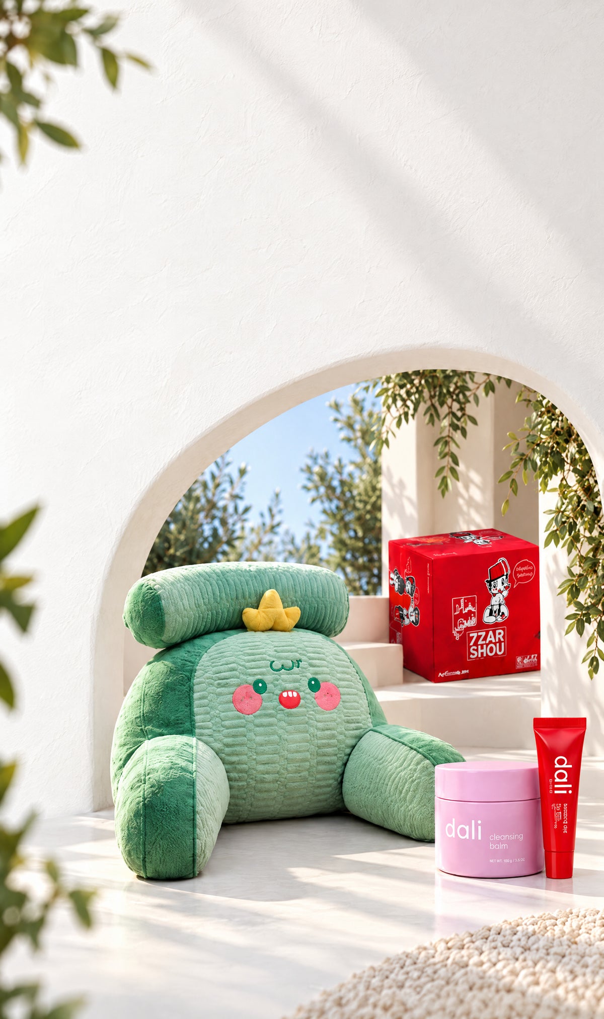 A sunlit white arch opening onto a garden, staged with Afkar Plus finds: a plush back-support pillow, the 7zar Shou game, Dali cleansing balm and lip butter