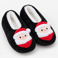 Black fuzzy Christmas slippers with a Santa face patch