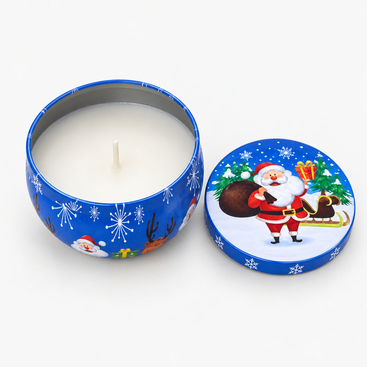 Blue Christmas candle tin with Santa and his sleigh, open with a white candle inside
