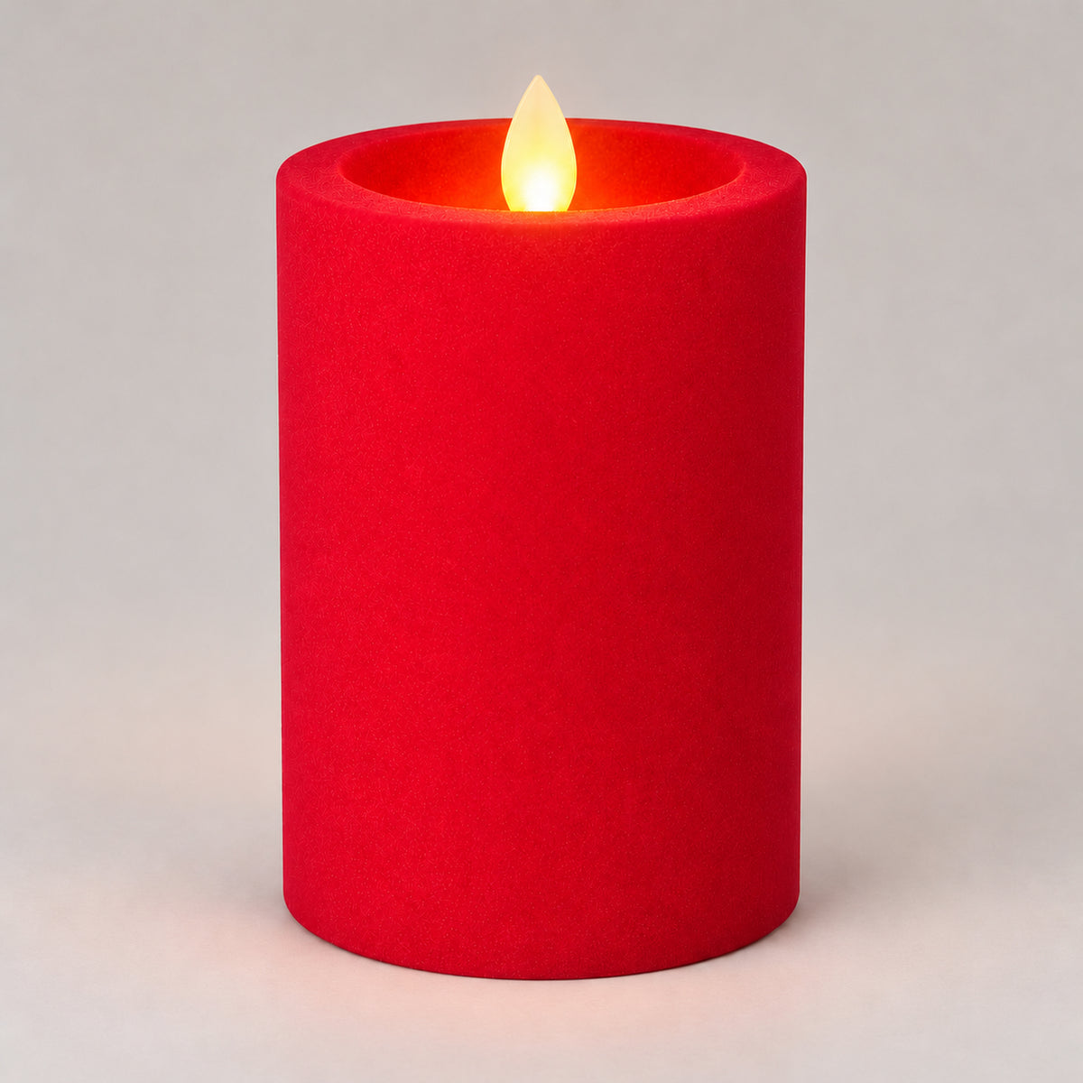 Red 12.5 cm LED pillar candle glowing with a dancing flame