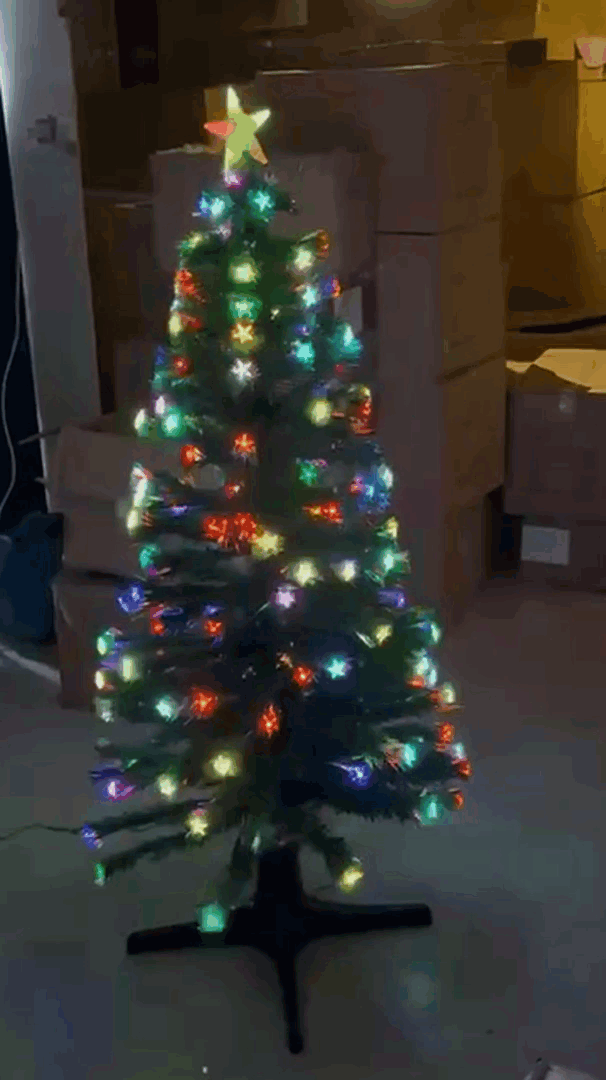 Christmas tree lit up with multicolor, color-changing star lights