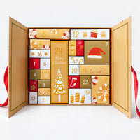 Gold Christmas advent calendar gift box open with 24 numbered compartments