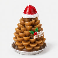 Gold pinecone Christmas candle in a Santa hat on a silver tray