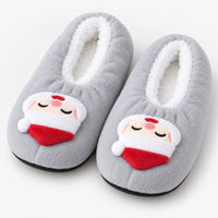 Gray fuzzy Christmas slippers with a Santa face patch