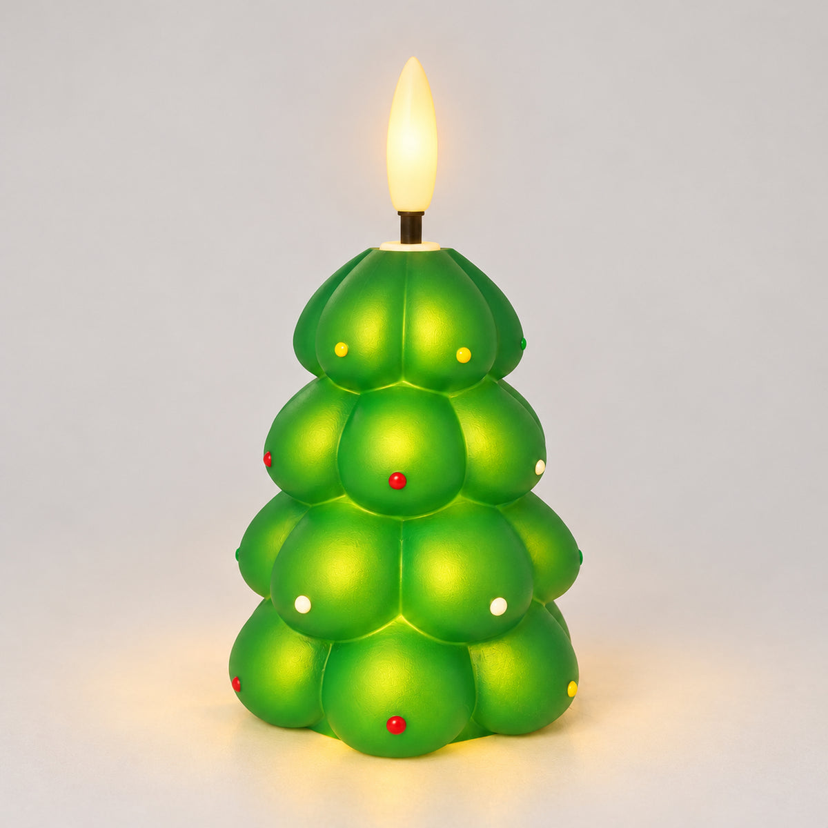 Green Christmas tree LED candle glowing with a warm LED flame
