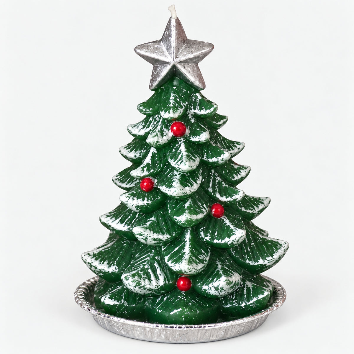 Green Christmas tree candle with a silver star on a silver tray