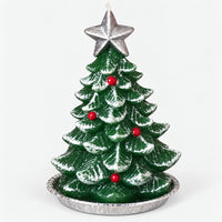 Green Christmas tree candle with a silver star on a silver tray