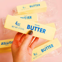 Hand squeezing a butter stick squishy