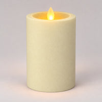 Ivory white 12.5 cm LED pillar candle glowing with a dancing flame