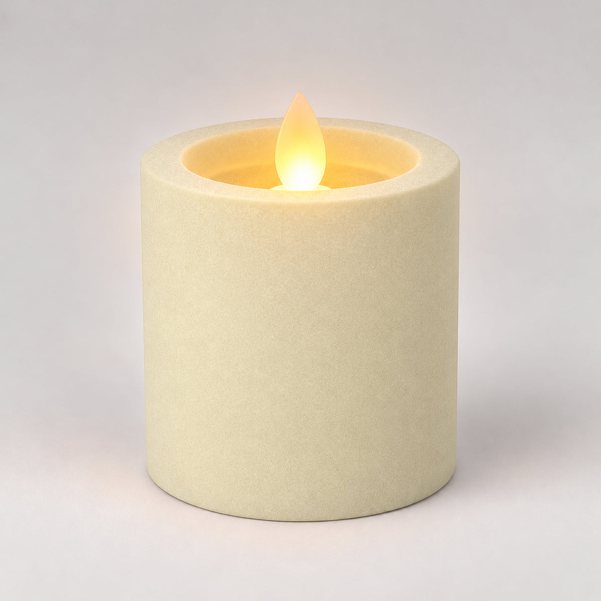 Ivory white 7.5 cm LED pillar candle glowing with a dancing flame