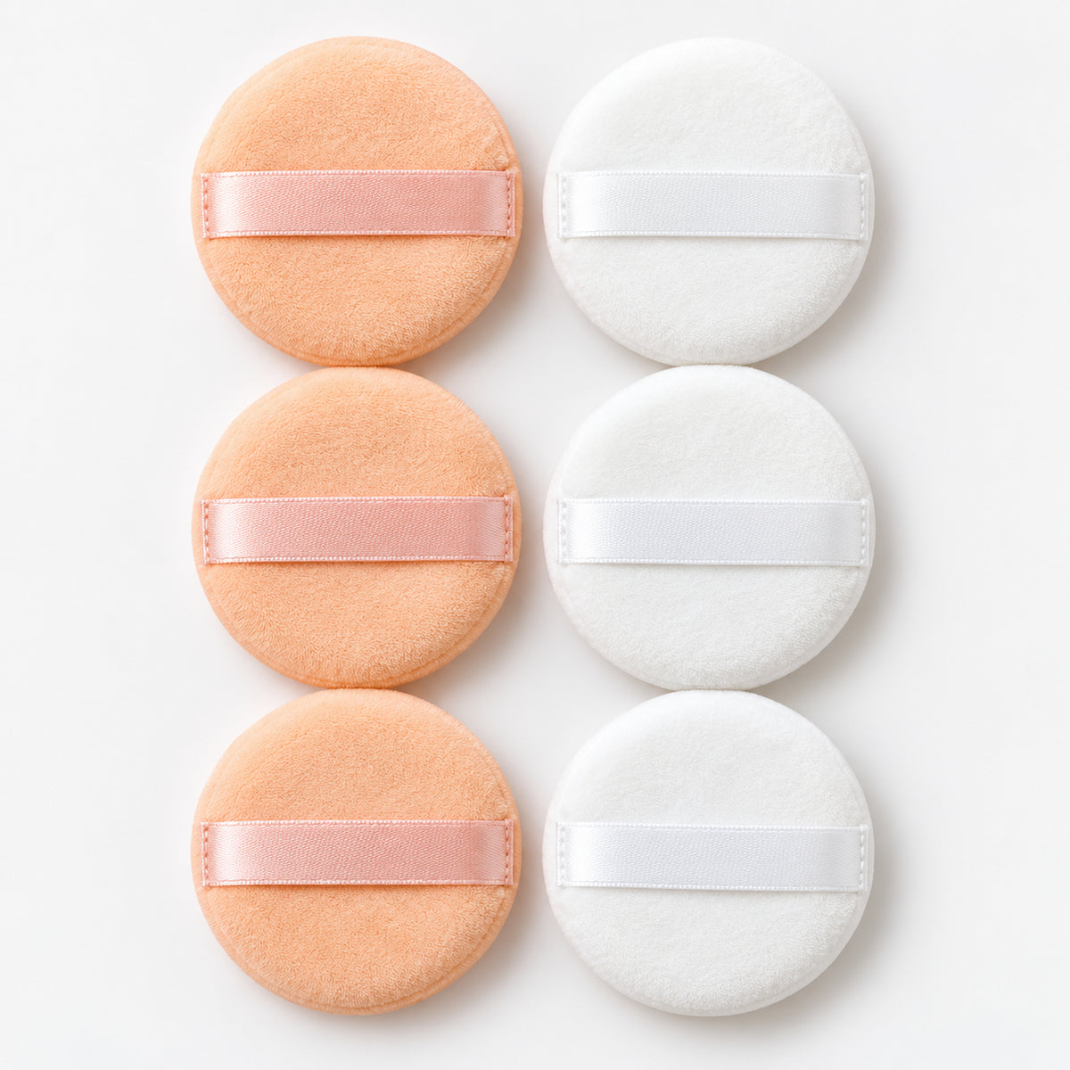 3 peach and 3 white round powder puffs with ribbon straps