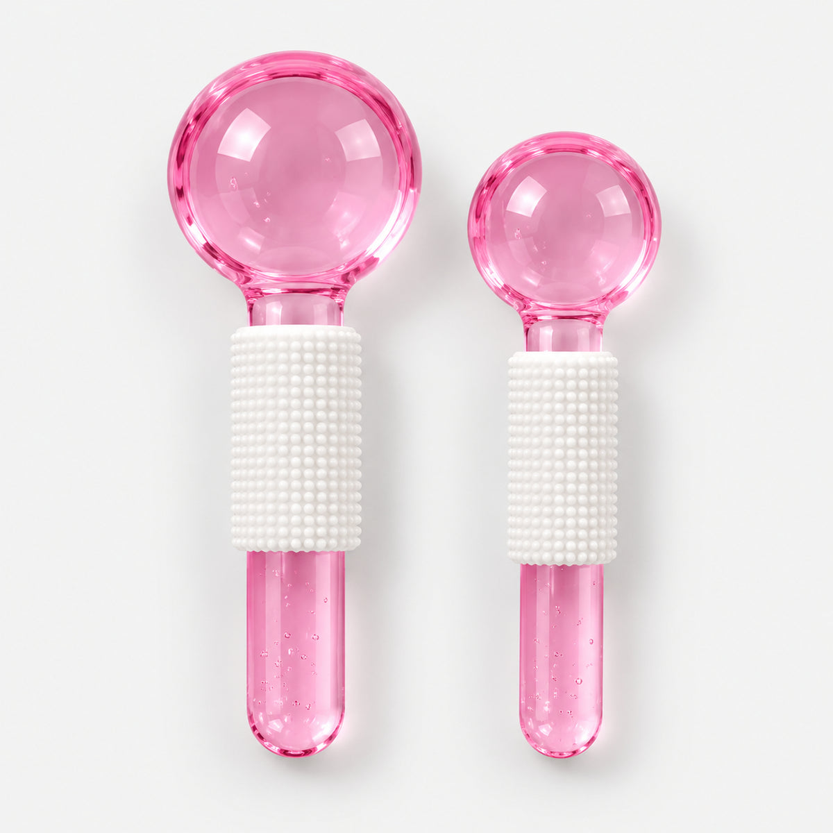 2 pink facial massage crystal balls, large and small, with white grips
