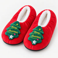 Red fuzzy Christmas slippers with a Merry Christmas tree patch