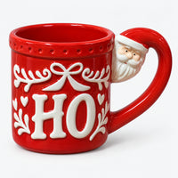 Red HO Christmas mug with a bow, holly and a Santa on the handle