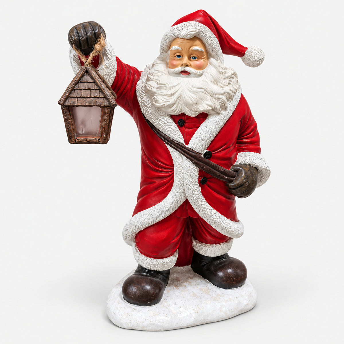 Santa figurine holding a lantern on a snowy base