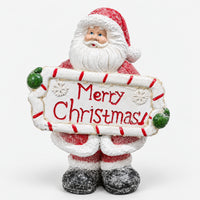 Glittery Santa figurine holding a Merry Christmas sign with a candy cane frame