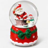 Christmas crystal ball with Santa in a chimney and a snowman, on a red base with a green bow