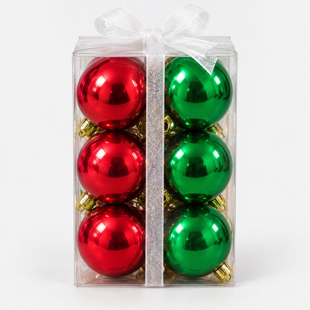 Red and green Christmas balls in a clear box with a white bow