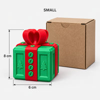 Small green & red prank gift box next to its kraft box