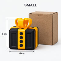 Small black & gold prank gift box next to its kraft box