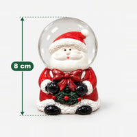 Santa with wreath Christmas snow globe measuring 8 cm high