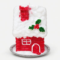 Red house Christmas candle with a snowy roof, chimney and holly