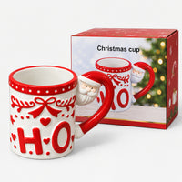 White HO Christmas mug next to its Christmas cup gift box