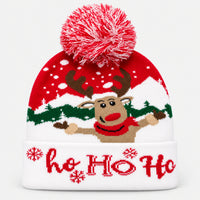 Red and white Ho Ho Ho reindeer Christmas knit beanie with a pom pom